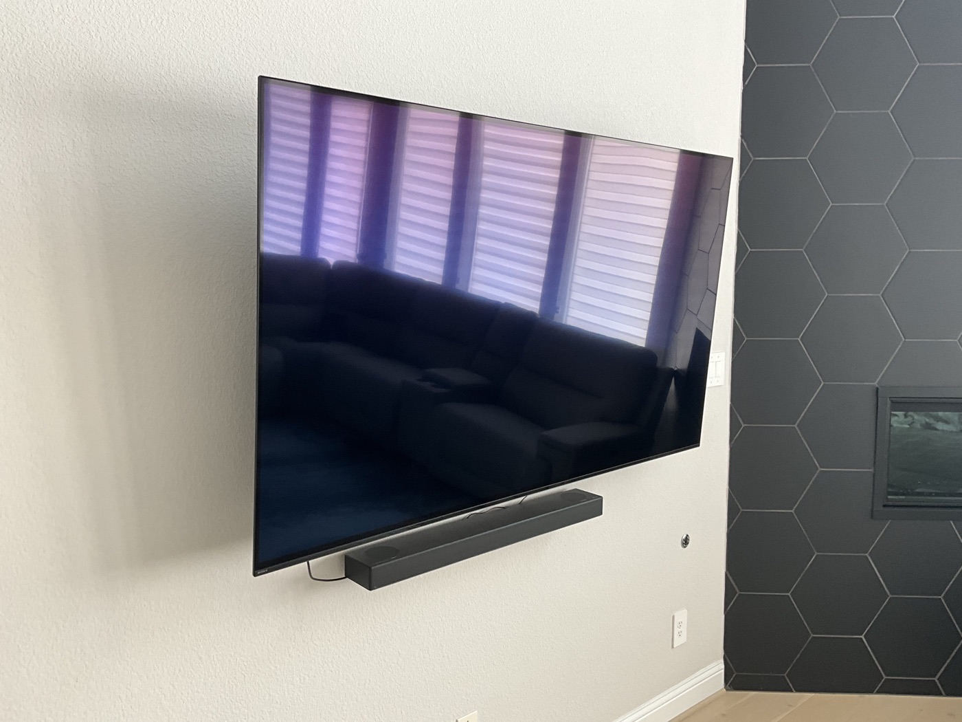 Wall-mounted television with a neatly aligned soundbar